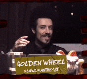 a man with a sign that says golden wheel
