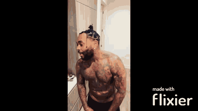 a shirtless man with a beard is making a funny face while standing in a bathroom .