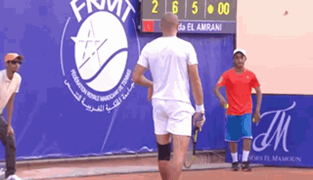 two men playing tennis in front of a scoreboard that says final