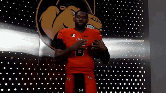 a man wearing an orange jersey with the number 8