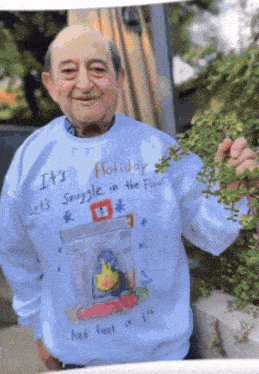 a man wearing a sweater that says it 's holiday