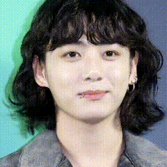 a close up of a woman 's face with short hair .
