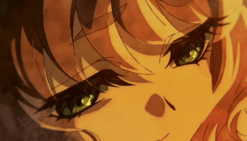 a close up of a girl 's face with green eyes and brown hair