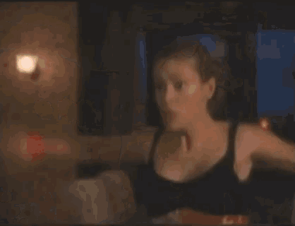 a blurred image of a person standing in a dark room with a red light behind them
