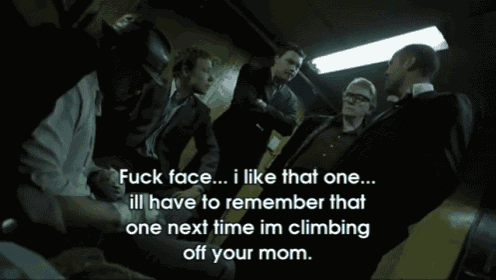 a group of people are gathered in a dark room and one of them says fuck face
