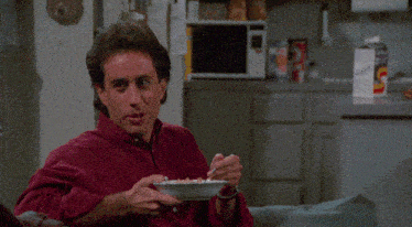 a man is holding a bowl of cereal and says " yeah "