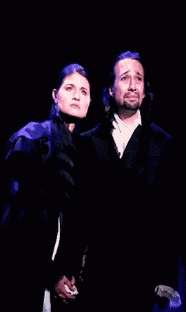 a man and a woman stand next to each other on a stage