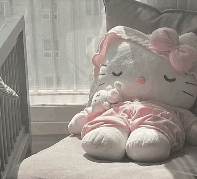 a stuffed hello kitty is sleeping on a chair