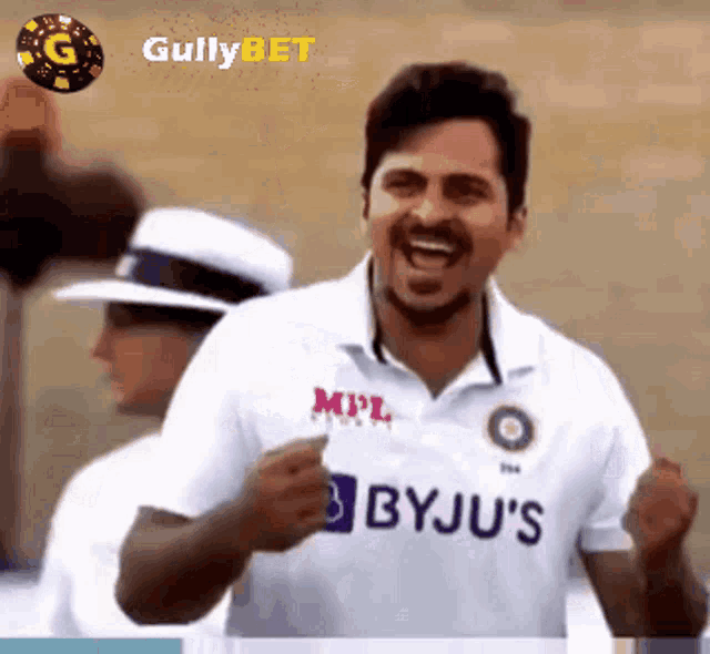 a man in a byju 's shirt is laughing