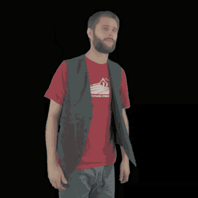 a man wearing a vest and a red shirt has the word mojster on the bottom right