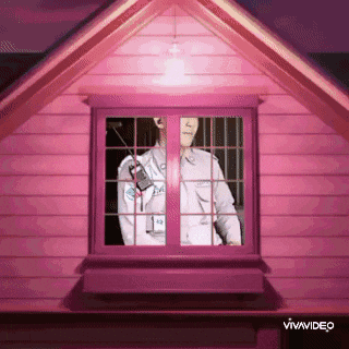 a pink house with a man in a uniform looking out the window