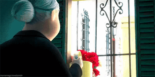 an animated image of an elderly woman looking out a window with the caption movemagiclovehumor