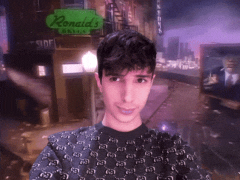 a young man taking a selfie in front of a sign for ronald 's grills
