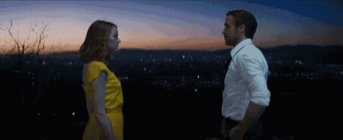 a man and a woman are looking into each other 's eyes .