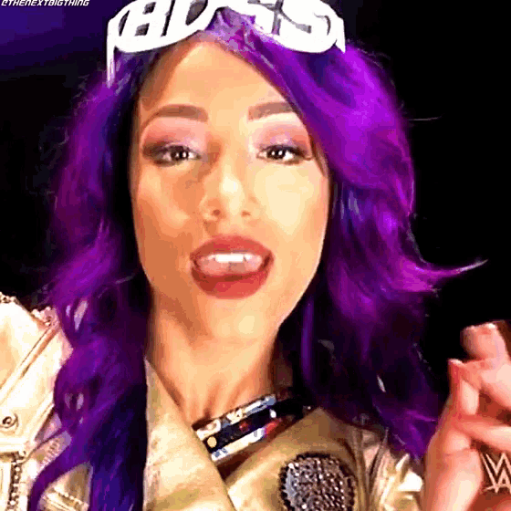 a woman with purple hair and goggles on her head .
