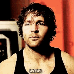 a man in a black tank top with the word wow written on his chest