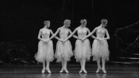 a group of ballerinas are standing next to each other on a stage in a black and white photo .