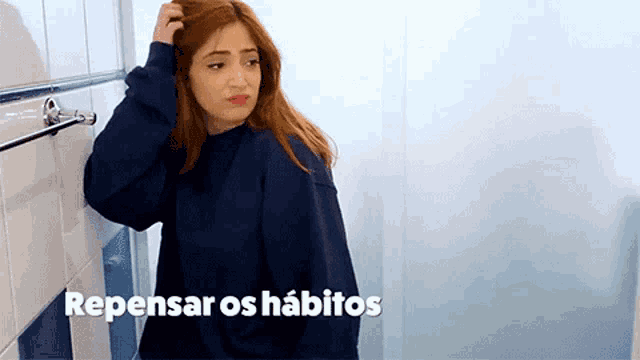 a woman standing in a bathroom with the words repensar os habitos written on the bottom