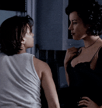two women are standing next to each other and one is wearing a black bra