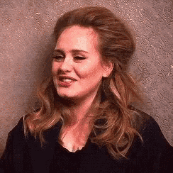 a close up of a woman 's face with a slight smile on her face .