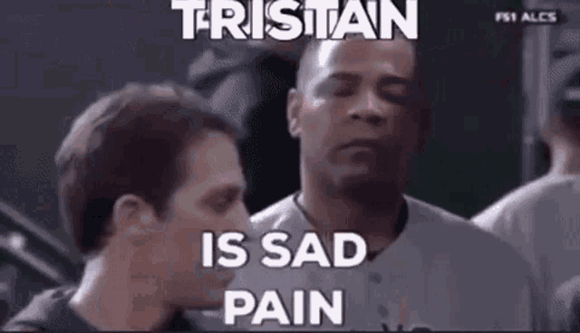 a couple of men are sitting next to each other and one of them is crying .