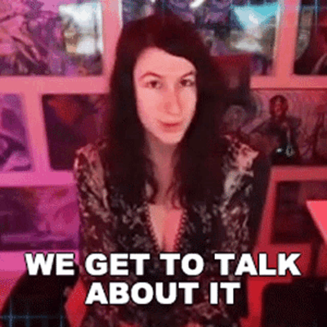 a woman is sitting in front of a wall with a sign that says " we get to talk about it "
