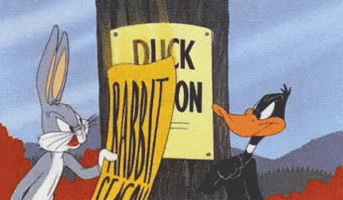 bugs bunny and daffy duck are looking at a duck rabbit on sign