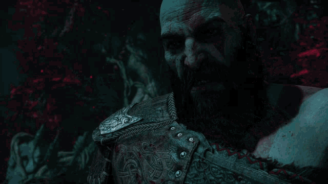a man with a beard is covered in blood and has a belt around his chest