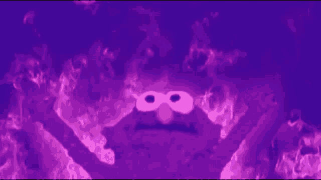 elmo from sesame street is surrounded by flames in a dark room .