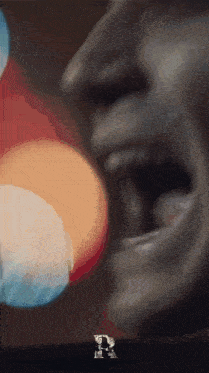 a close up of a person 's face with the letter r in the corner