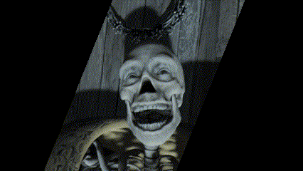 a black and white photo of a skeleton with a chain around his neck