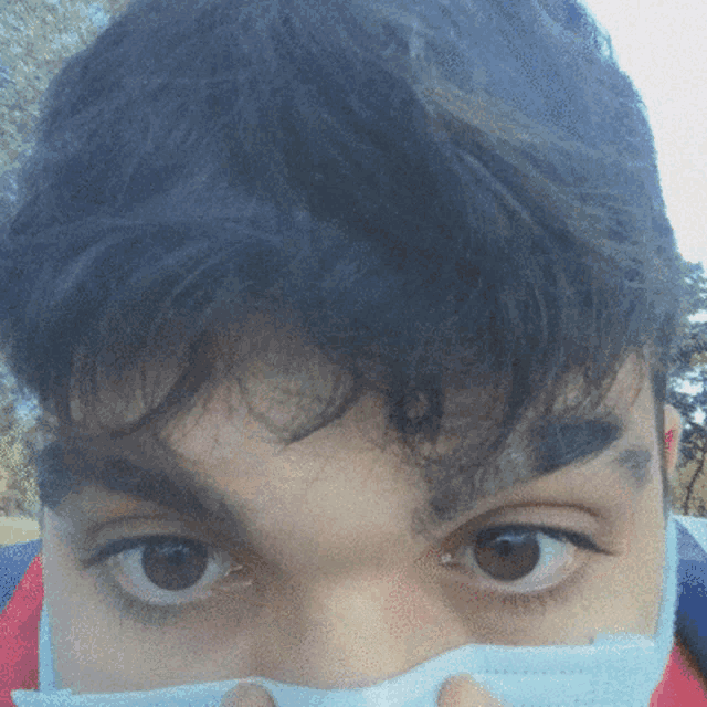 a close up of a person 's face with a white mask on