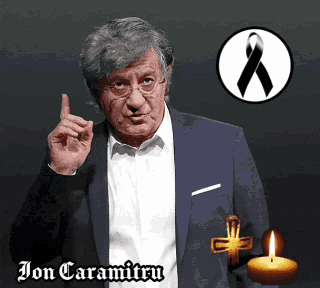 a picture of jon caramitru with a cross and a black ribbon