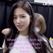 a girl with long hair is wearing a white shirt and talking about her friends .