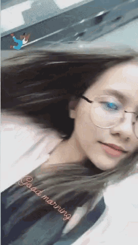 a woman wearing glasses says good morning on the bottom right