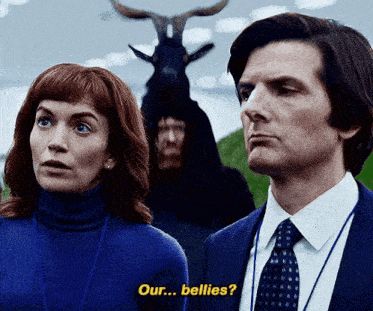 a man and a woman are standing next to each other and the man is wearing a goat costume