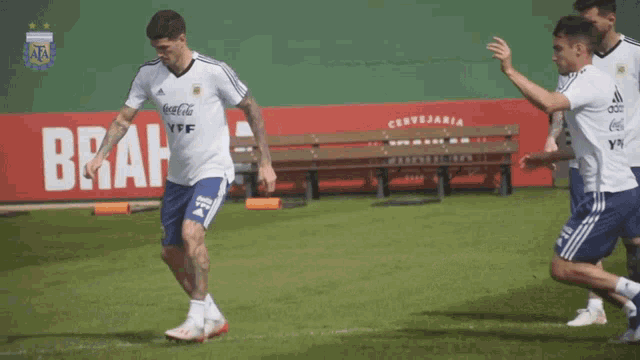 a soccer player wearing a coca cola ypf jersey kicks a soccer ball