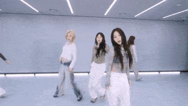 a group of girls are dancing in a room