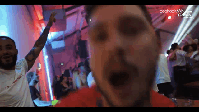 a man in a red shirt with the word boohooman on the top