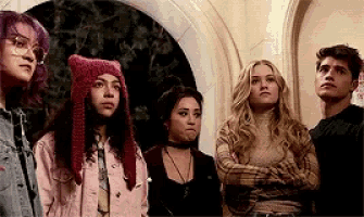 a group of young people are standing next to each other in a room .