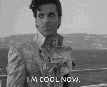 a black and white photo of a man in a suit saying `` i 'm cool now . ''