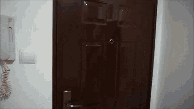 a door with a telephone next to it that says ' tl ' on it