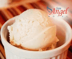 a scoop of vanilla ice cream is in a white bowl with the words san angel hotel written on the bottom