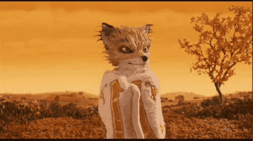 a fox wearing a white blanket with the number 1 on it stands in a field