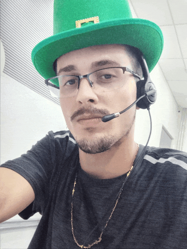 a man wearing a green hat and headphones with the letter s on it