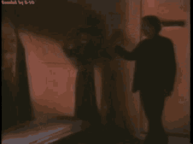 a man and a woman are standing next to each other in a room .