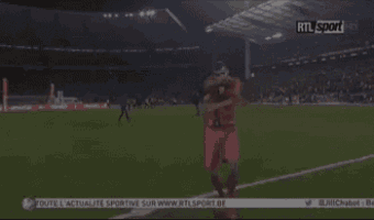 a man on a soccer field with rtl sport on the bottom right