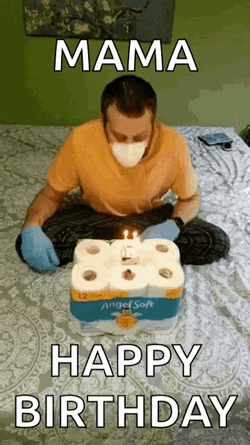 a man wearing a mask and gloves sitting on a bed with a birthday cake made out of toilet paper