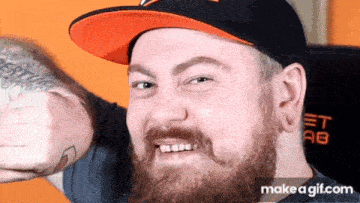 a man with a beard is wearing a hat and giving a thumbs up .