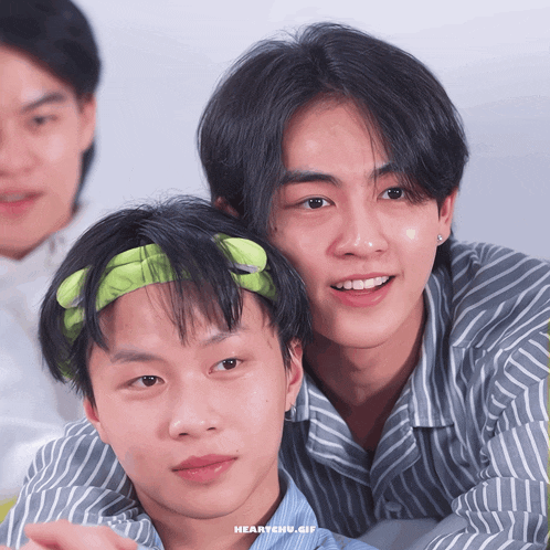 two young men are posing for a picture and the words heartchu.gif are on the bottom